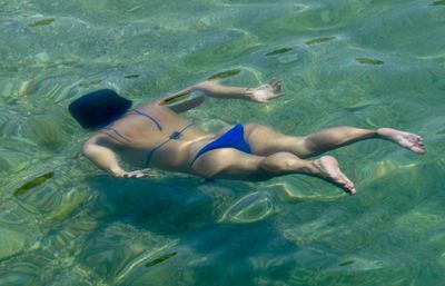 High angle view of woman swimming in sea