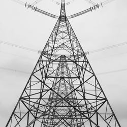 Low angle view of electricity pylon against sky