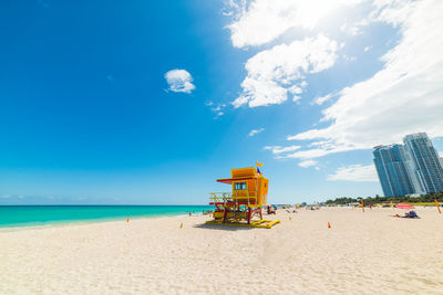 Lifeguard hut on beach against sky