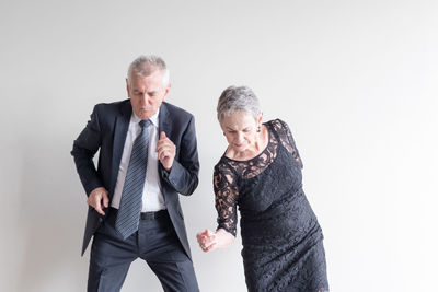 Friends standing against white background