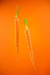 Close-up of pumpkin against orange background