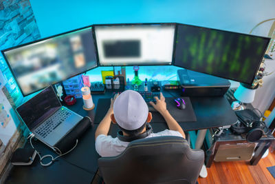 Rear view of man working on table