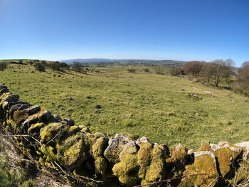 Scenic view of land against clear blue sky