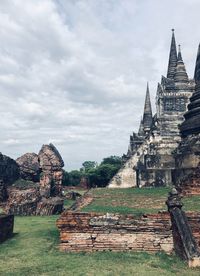 Old temple building against cloudy sky