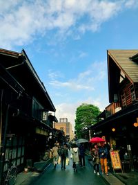 People in city against sky