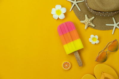 High angle view of various shoes on yellow background