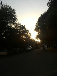 Cars on road at sunset