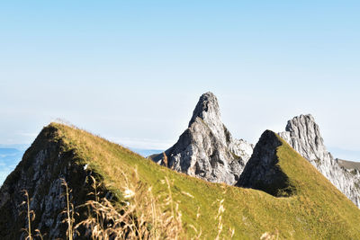 Scenic view of sea and mountains against clear sky
