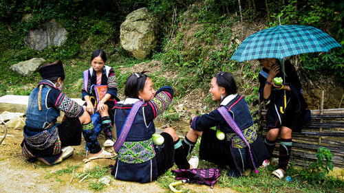 Group of people sitting in the forest