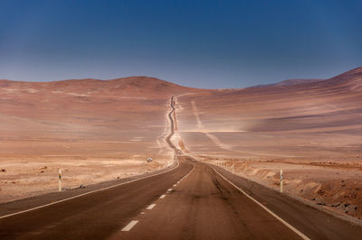 Road in desert against clear sky