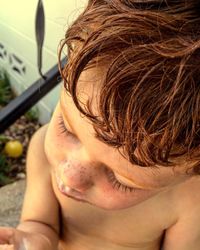 High angle view of shirtless boy at back yard