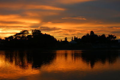 Scenic view of lake against orange sky