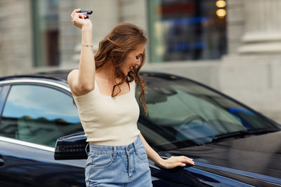 Side view of young woman using mobile phone