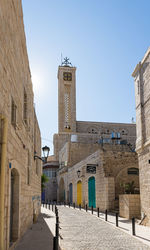 Buildings in city against clear sky