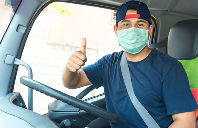 Portrait of man sitting in car