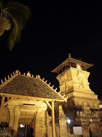 Low angle view of illuminated building against sky at night