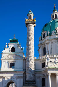 Low angle view of historical building against clear blue sky