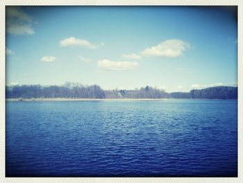 Scenic view of lake against cloudy sky