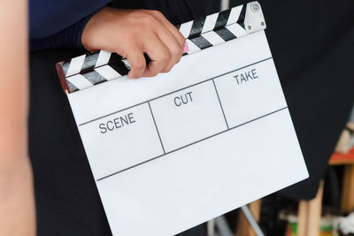 Close-up of person holding film slate