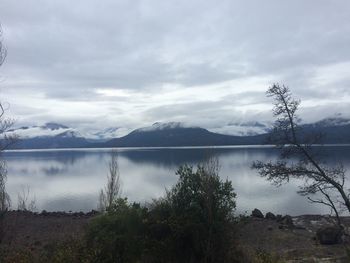 Scenic view of lake against cloudy sky