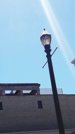 Low angle view of illuminated street light against clear sky