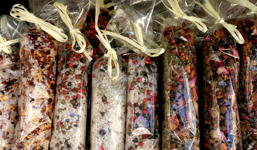 Colourful various italian herbs and spices in beautiful small transparent wrapping bags for sale.