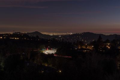 High angle view of illuminated buildings in city at night