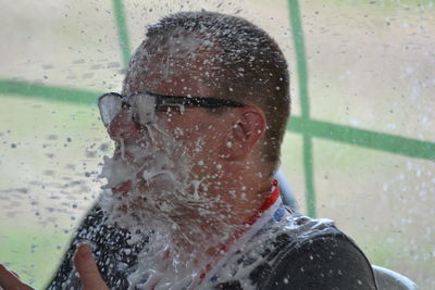 Close-up portrait of wet glass