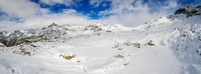 Scenic view of snow covered mountains against sky