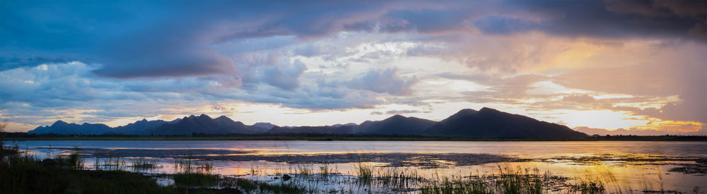 Panoramic view of lake and mountains during sunset