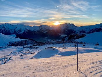 Scenic view of snowcapped mountains against sky during sunset