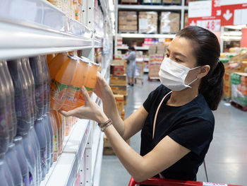 Portrait of woman standing at store