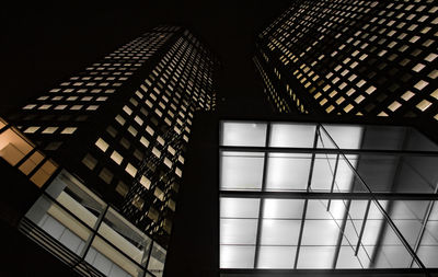 Low angle view of illuminated building against sky at night