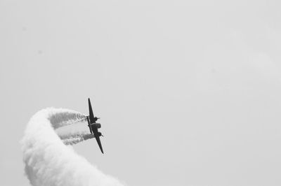 Low angle view of airshow against clear sky