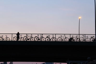 Low angle view of people walking on bridge