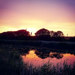 Scenic view of lake at sunset