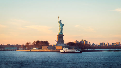 Statue of liberty with city in background