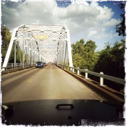 View of bridge against cloudy sky