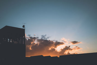 Silhouette of built structure at sunset