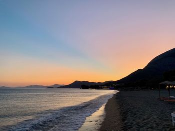 Scenic view of beach against sky during sunset