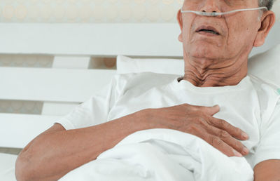 Portrait of man sitting on bed