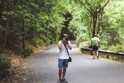 Rear view of man walking on road