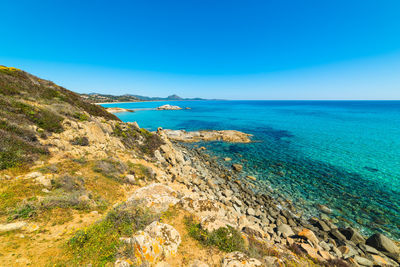 Scenic view of sea against clear blue sky