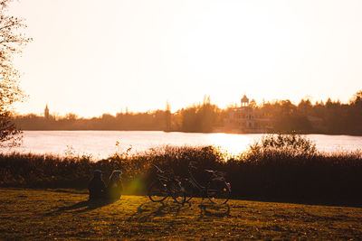 Scenic view of lake against clear sky during sunset