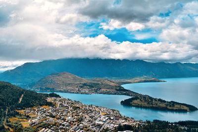 Panoramic shot of townscape by sea against sky