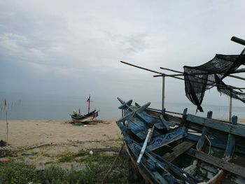 Boats moored on sea against sky