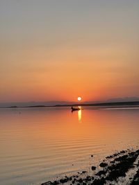 Scenic view of sea against romantic sky at sunset