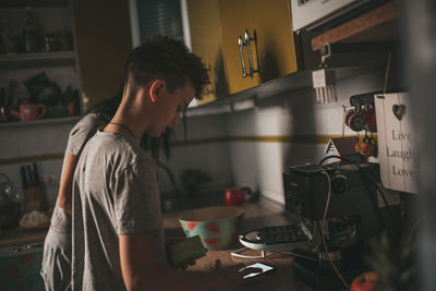 Side view of young man looking at home