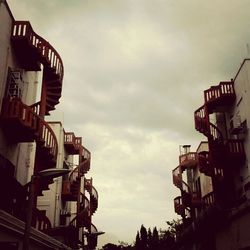 Low angle view of built structure against cloudy sky