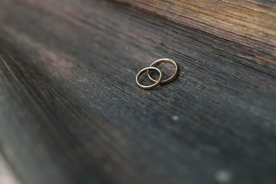 High angle view of wedding rings on wooden table